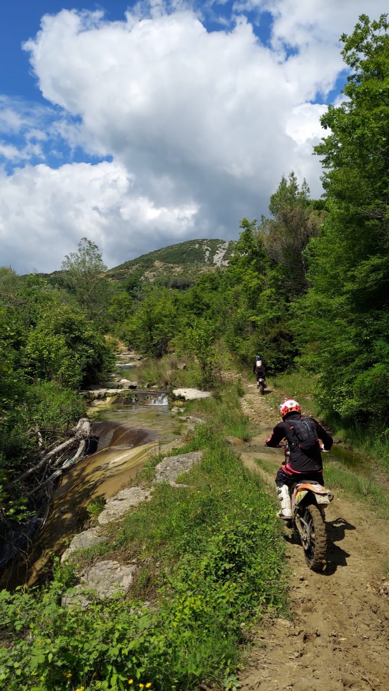 Enduro trail riding beside a mountain river